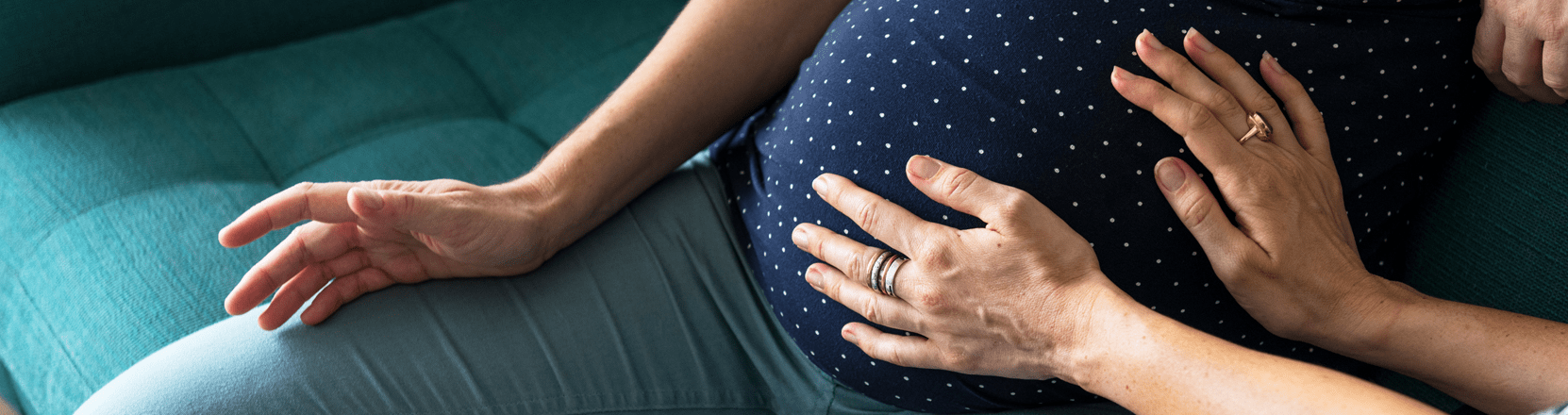 Image of an two individuals and one is pregnant