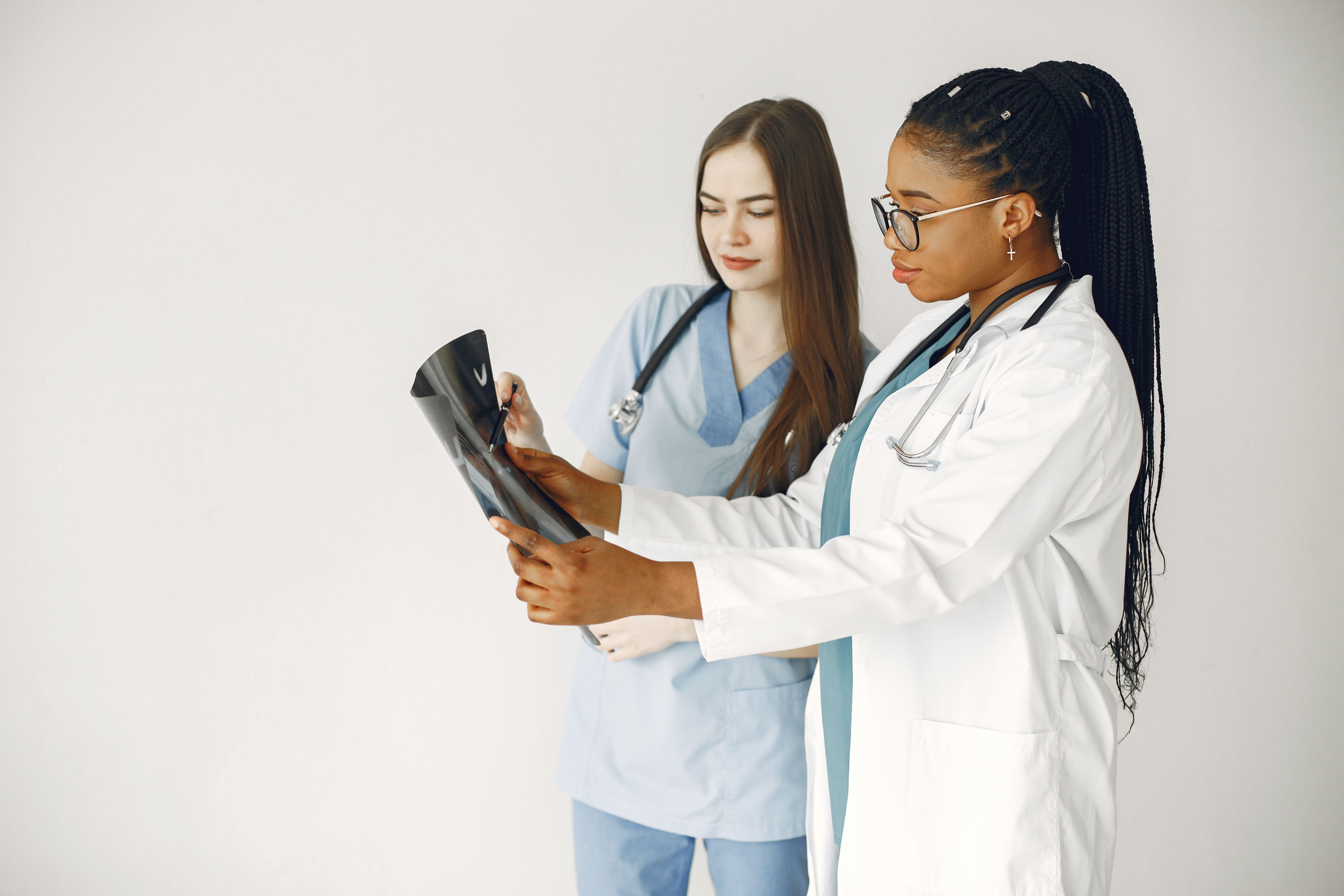 A doctor and a physician's assistant examine an x-ray