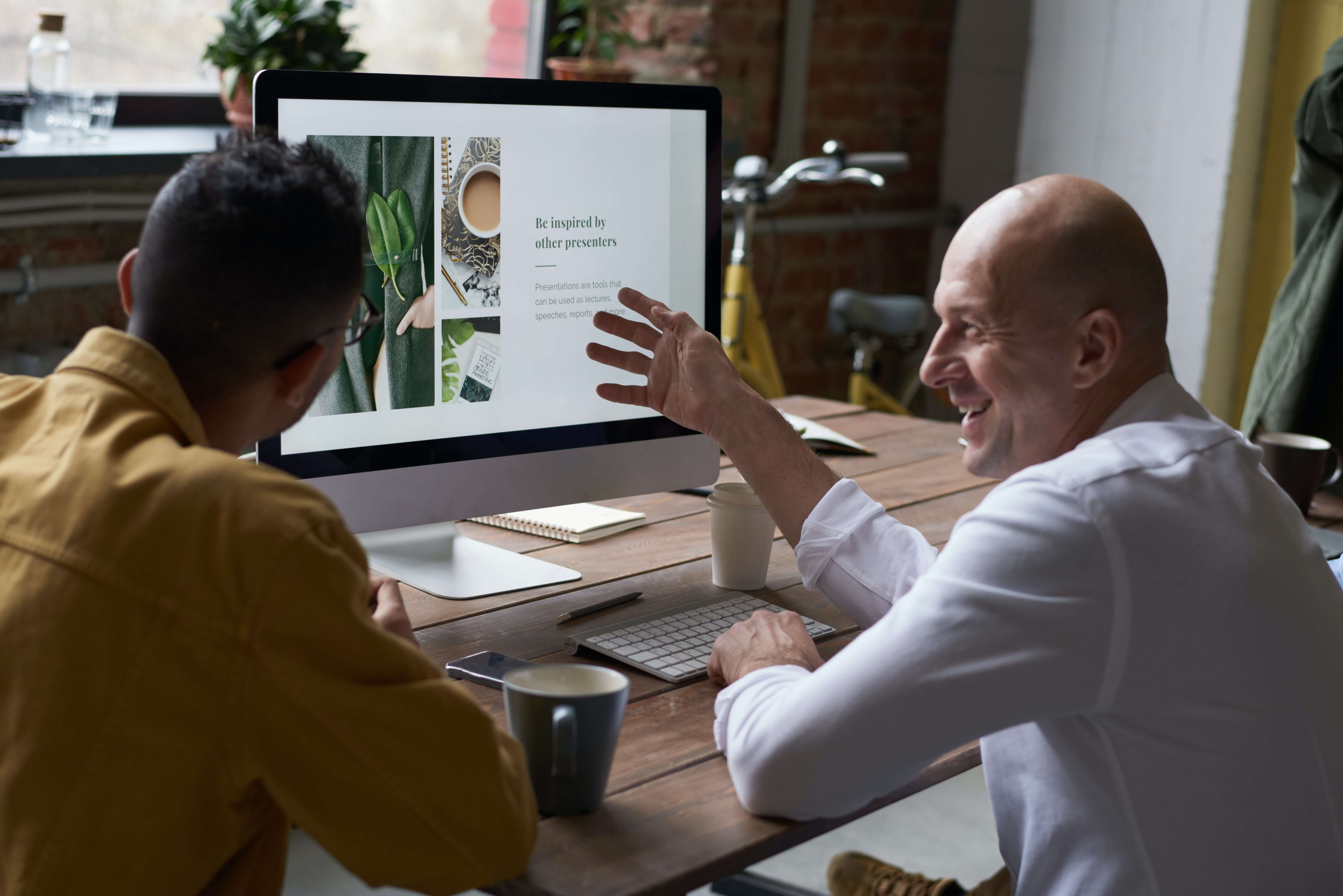 Two people discussing an image on a computer screen