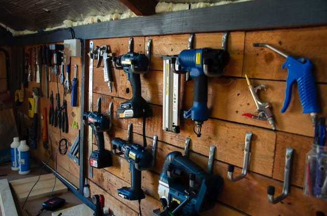 A bunch of tools hanging on a wall