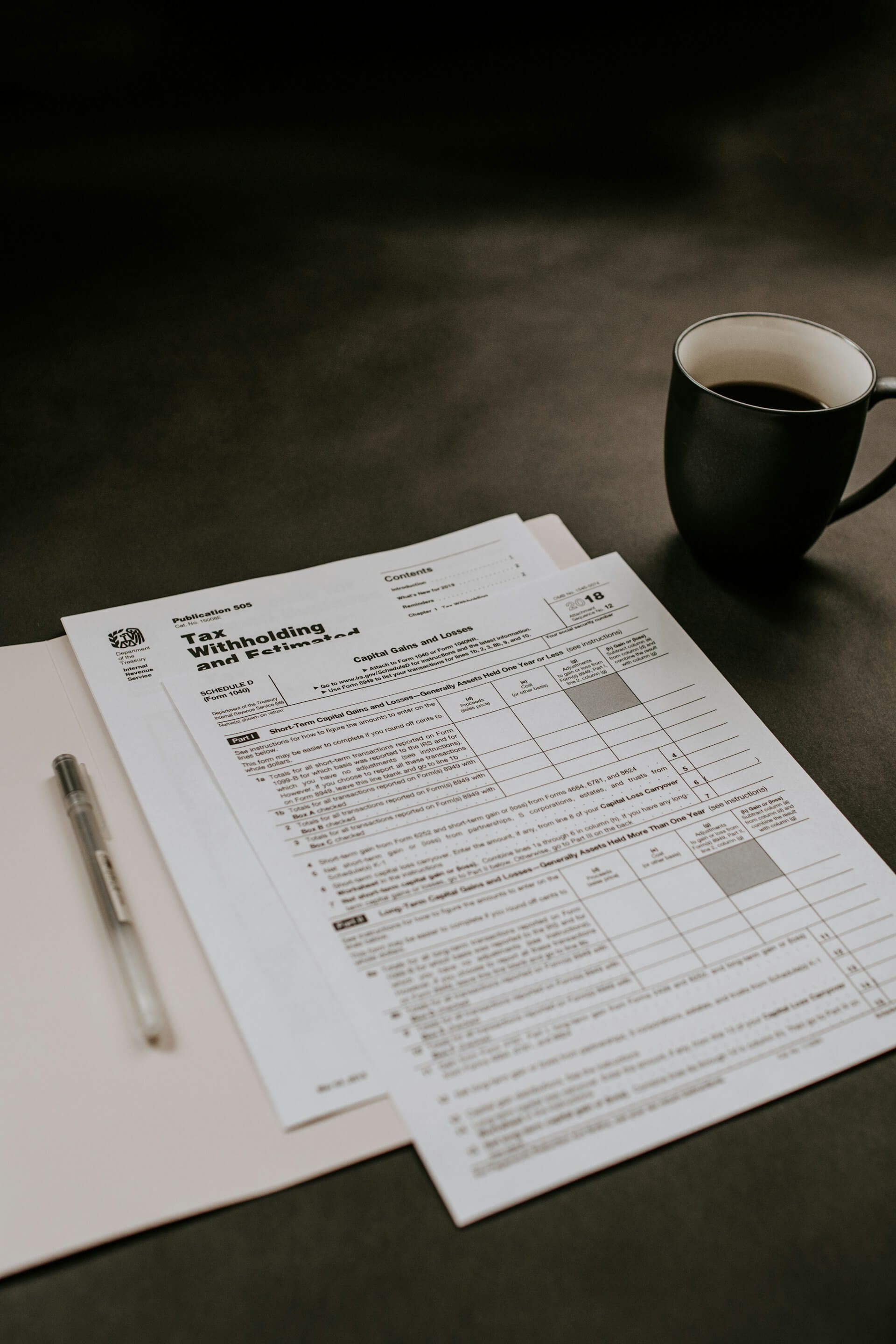 Tax forms, pen and coffee