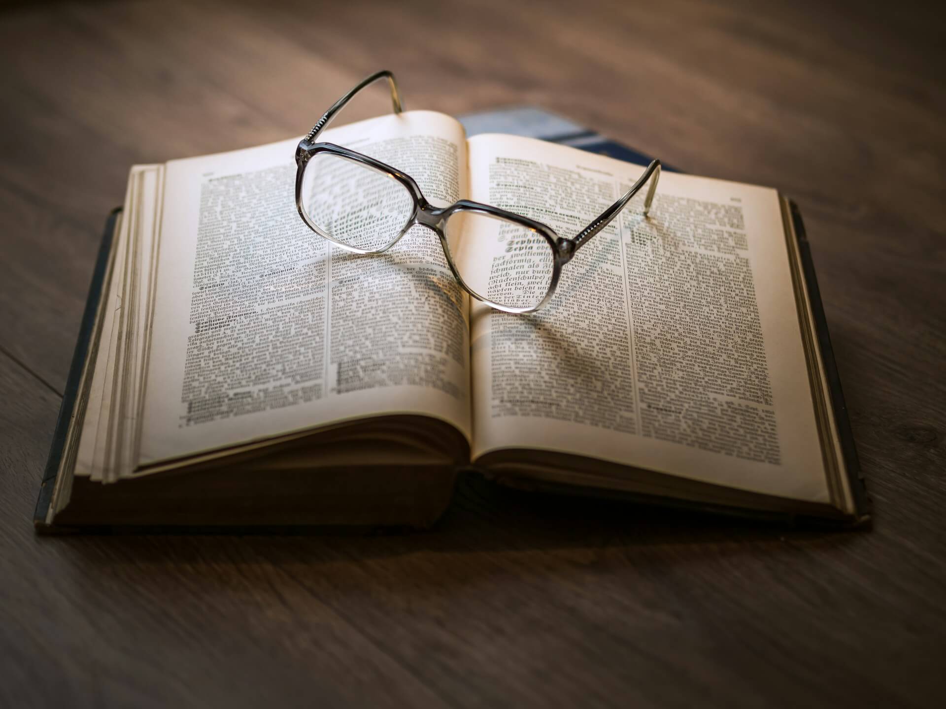 Glasses sitting on top of an open book