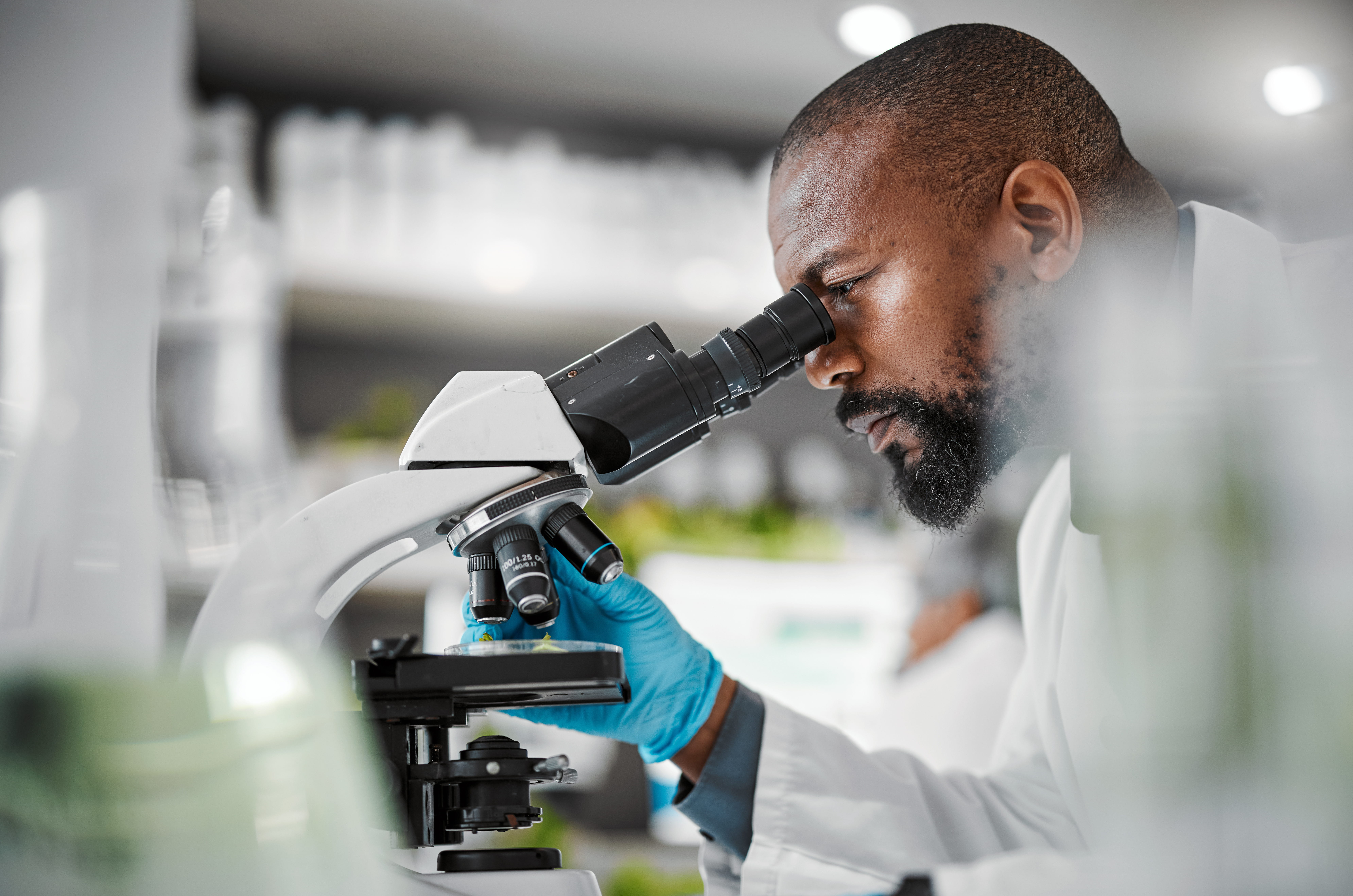 Man looking down a microscope.