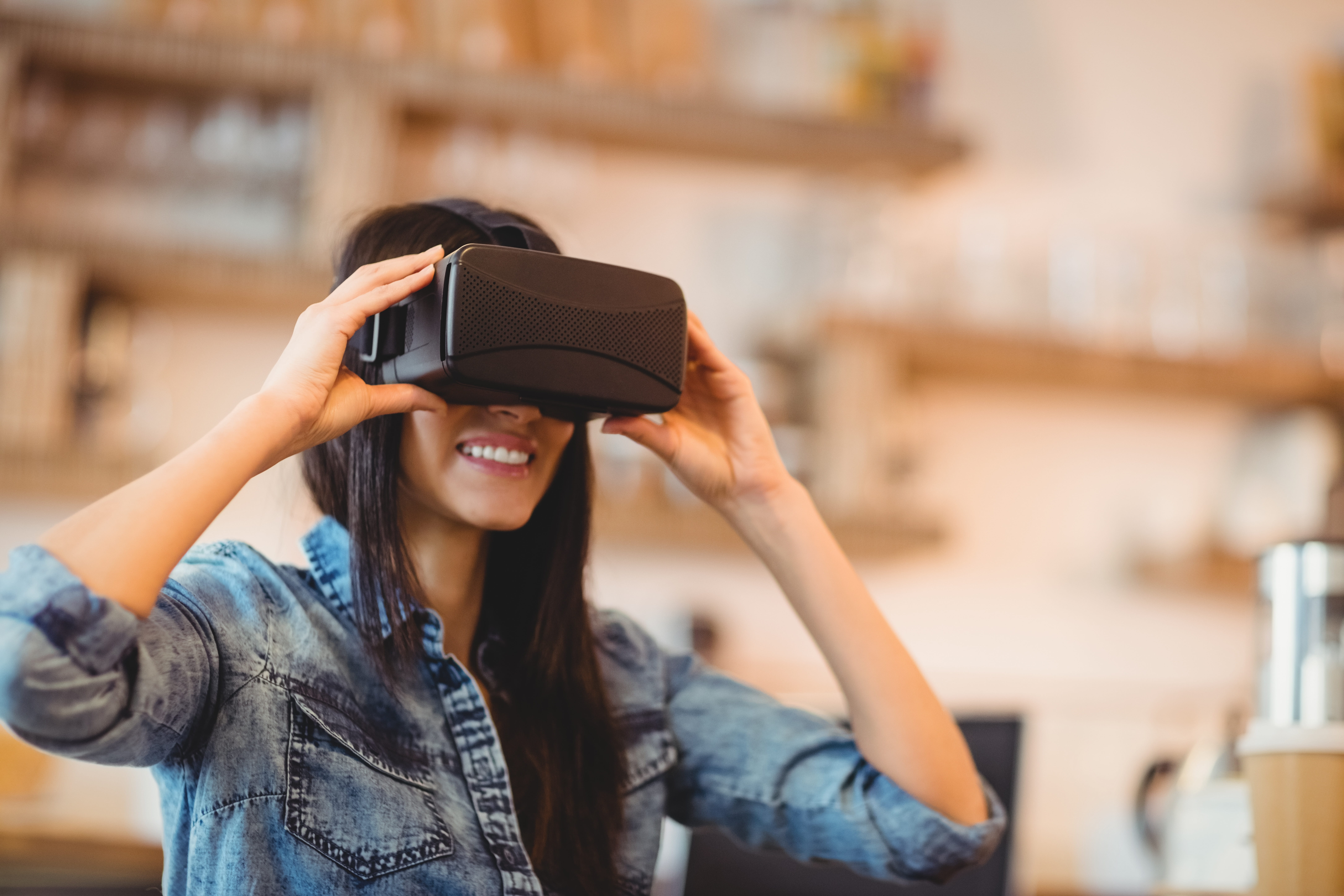 A woman looking through virtual reality glasses