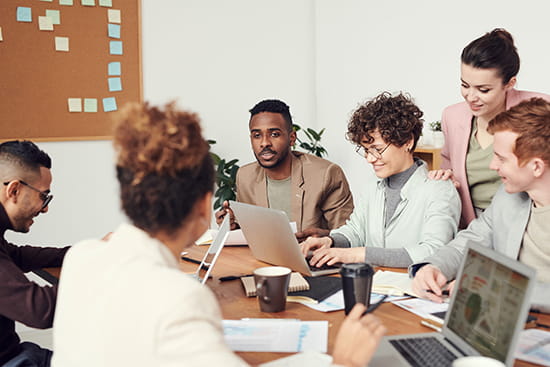 Group of people around table working