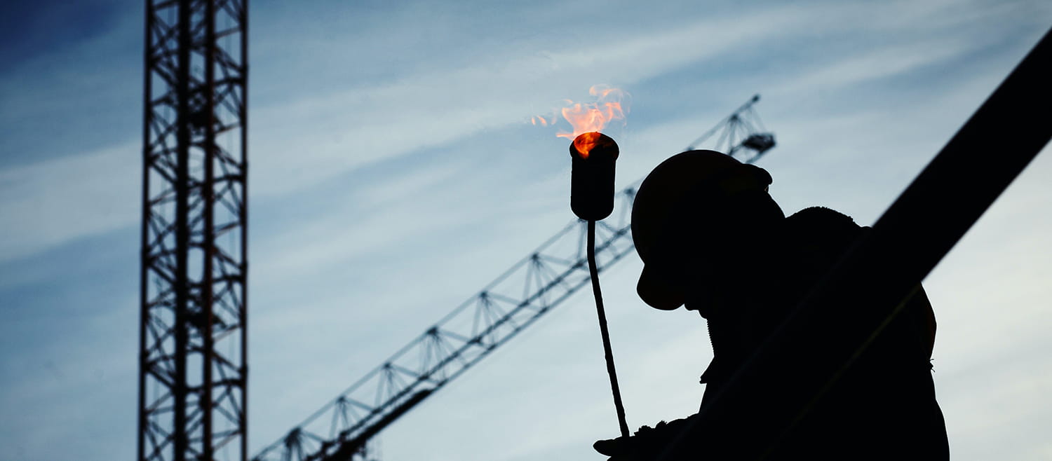 construction worker with crane in background