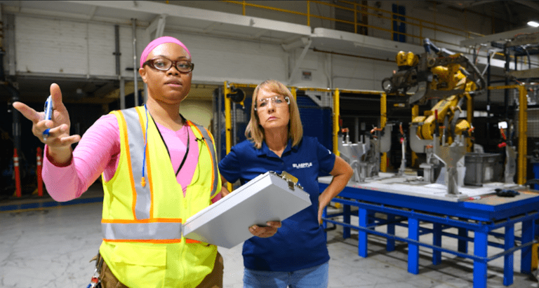 MIOSHA safety officer and employee reviewing documents inside Laepple Automotive’s Detroit auto parts plant.
