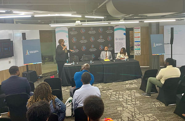 LEO Deputy Director Kim Trent and BLAC Co-Chairs Christopher Burtley and Dr. Donna Bell present to an audience