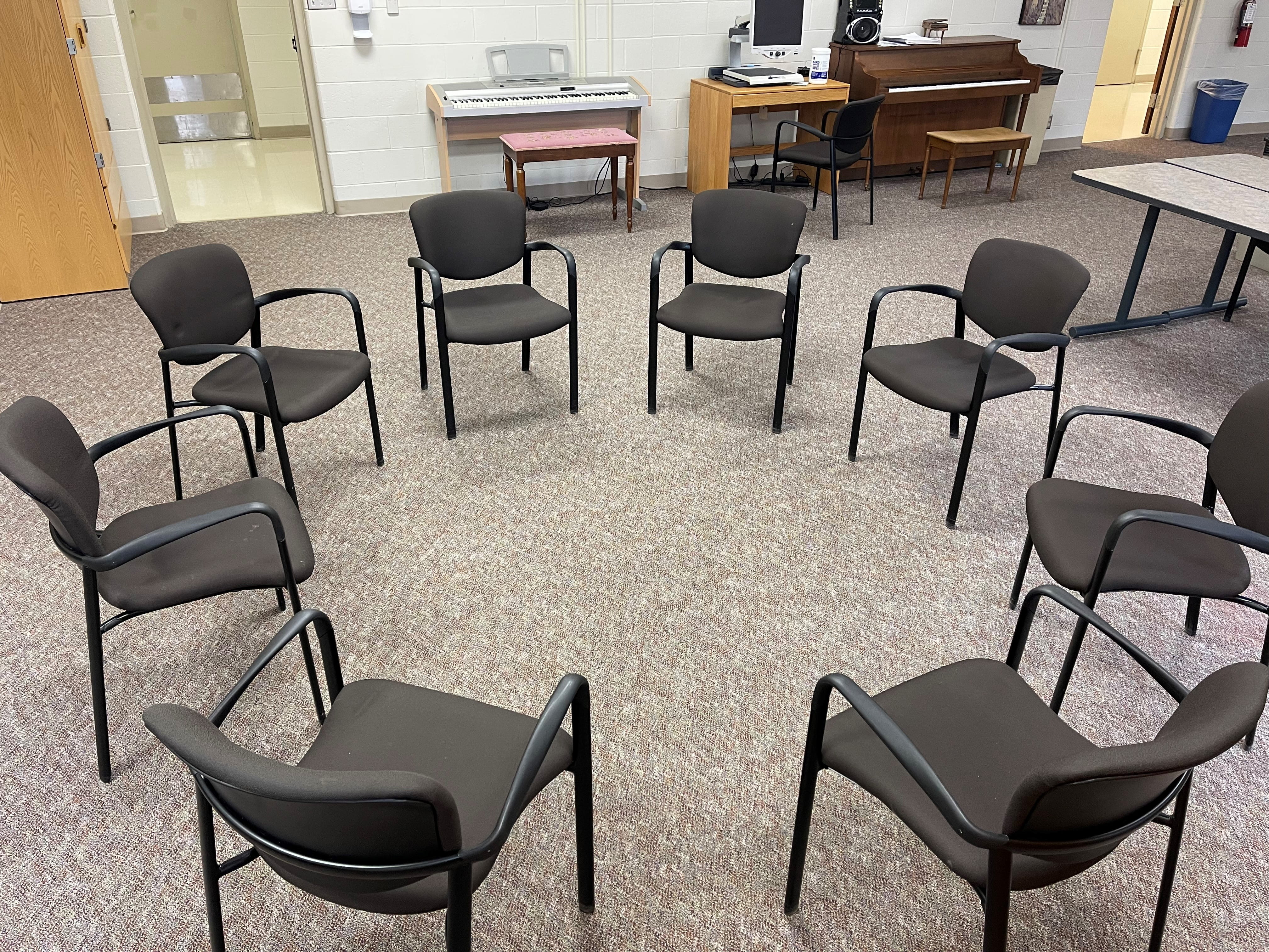 Room set up with chairs in a circle