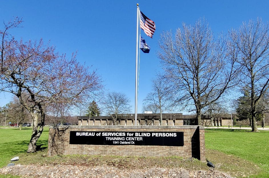 Front of BSBP Training Center building with the sign on the lawn.