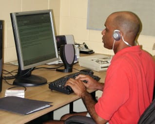 Student sitting a computer