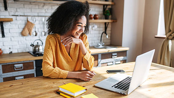 a woman working from home in her kitchen