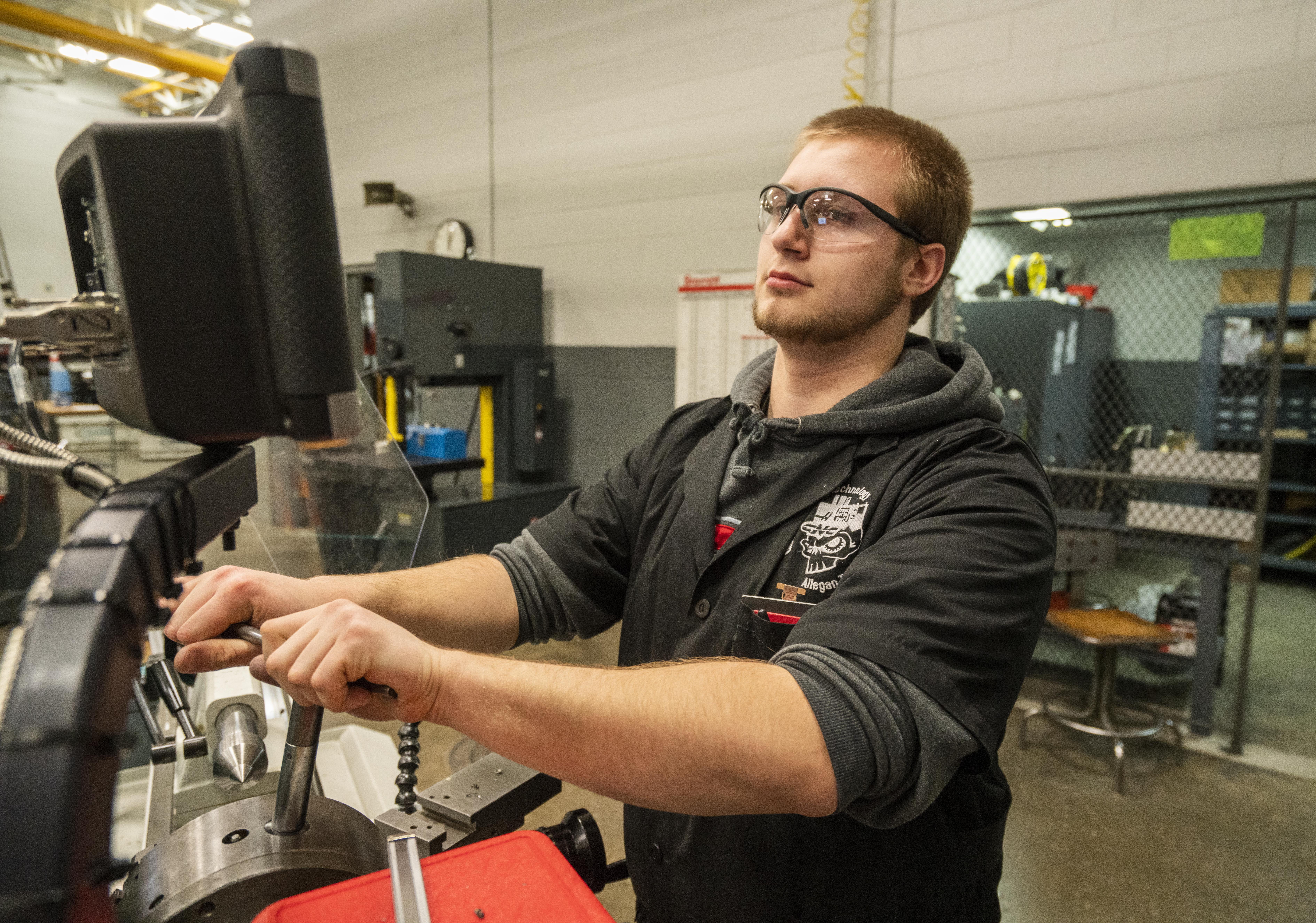 James Page works on a CNC machine in his Early College Allegan County class. 