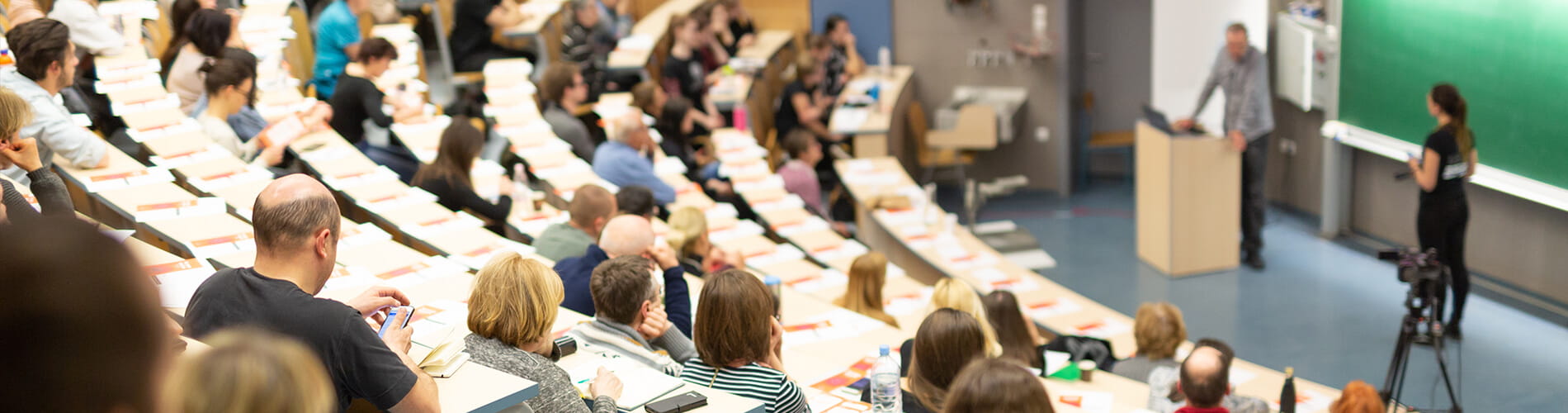 Students in a lecture hall listening to teacher