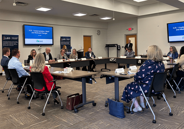 SOM employees sitting at roundtable discussing SNAP work requirement