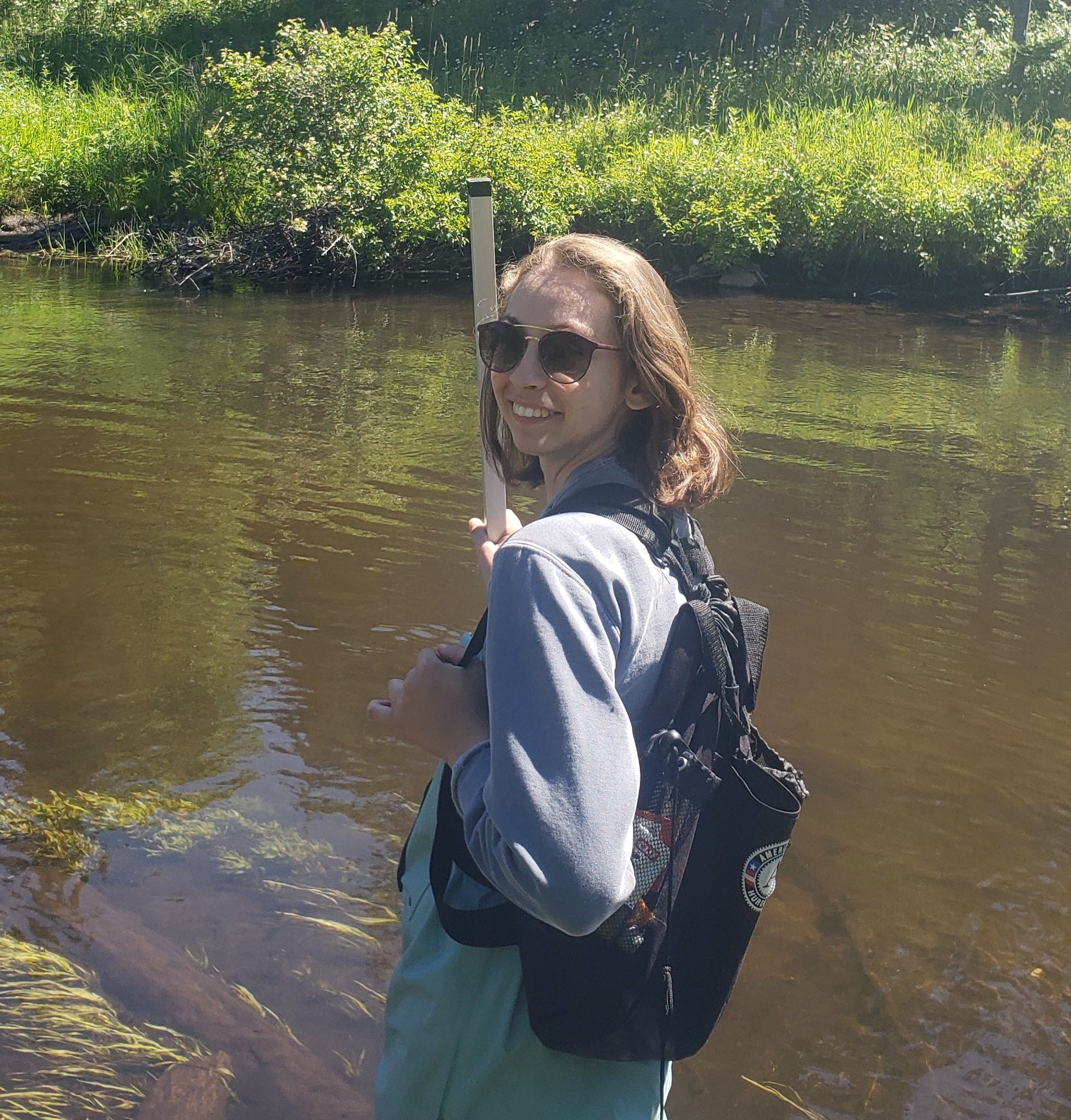 Leah Higgins standing in a small body of water. 