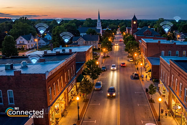a rural downtown at night with wi-fi symbols above it