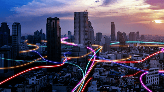 tall buildings in a city's downtown showing neon lines in between representing connectivity