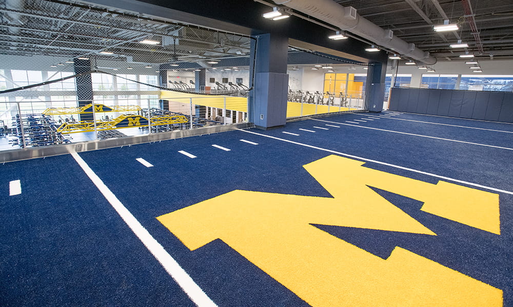 Athletics training field with University of Michigan "M" logo. 