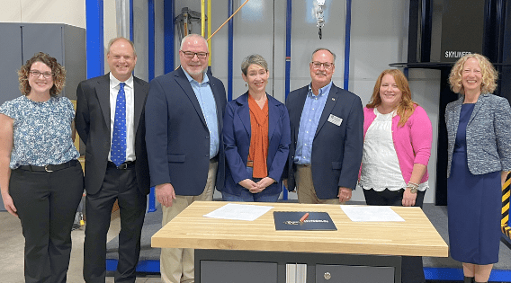 MIOSHA and Grand Valley State University staff are pictured standing around a table 