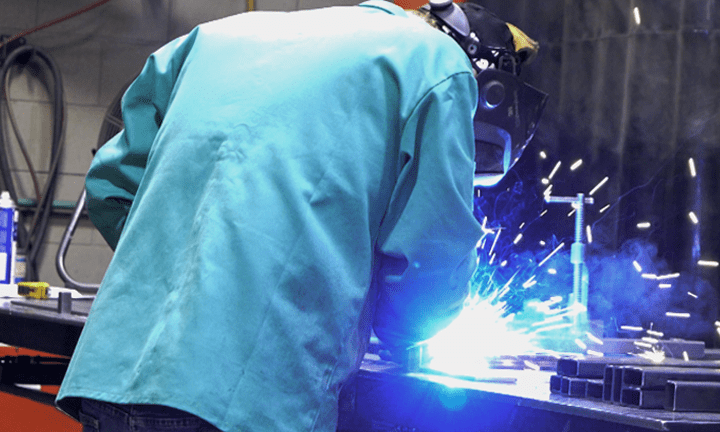 person welding at welding table