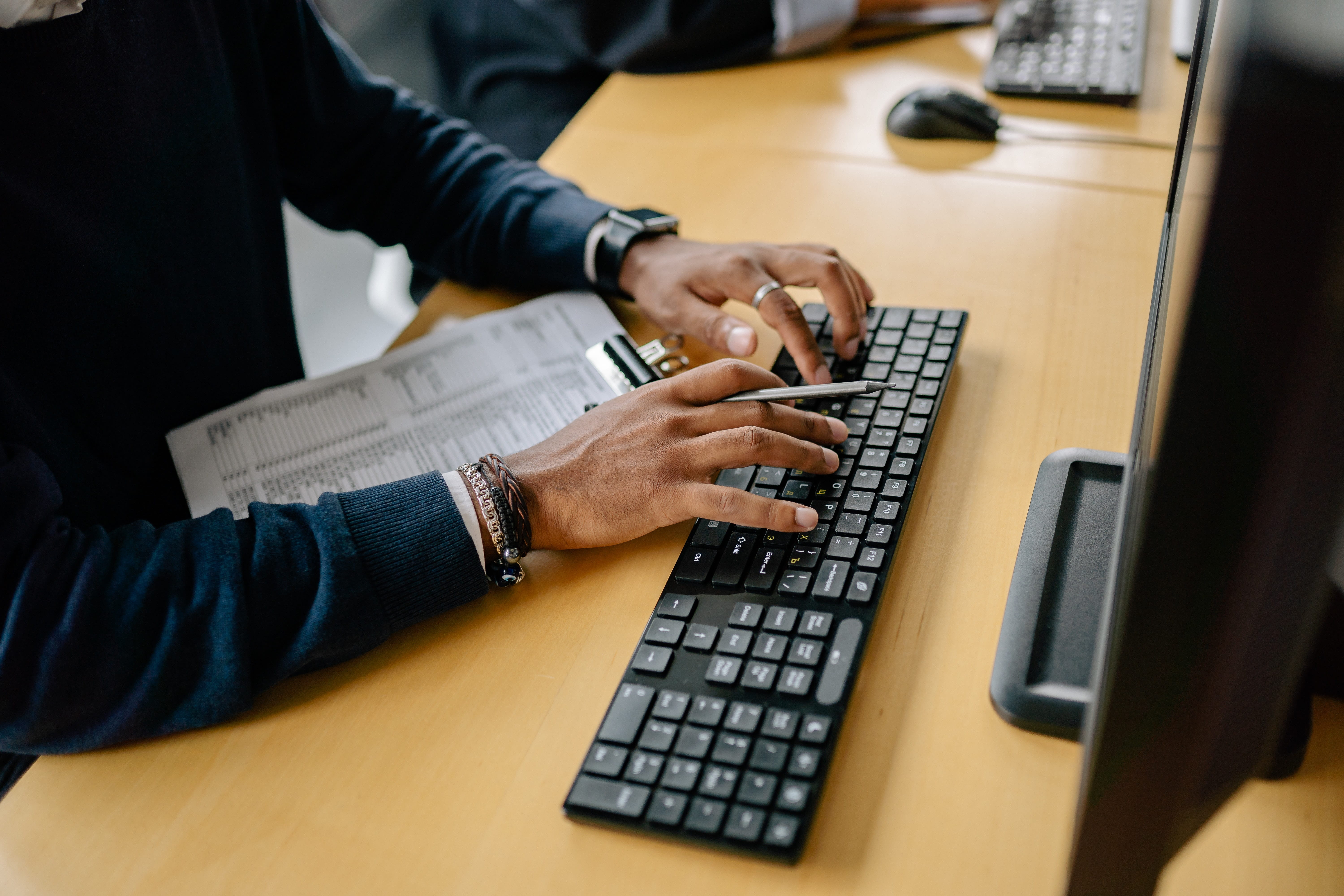 Hands typing on keyboard
