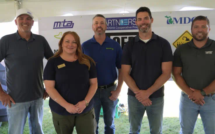MIOSHA and Toebe Construction representatives standing together at an alliance renewal event.