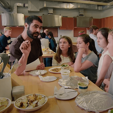 A group of students eating at a table.