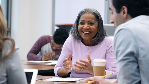 three teachers at a table talking