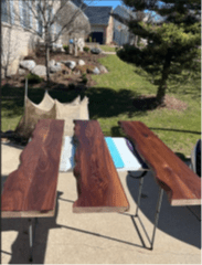 Overhead view of three wooden shelves laid out outside.