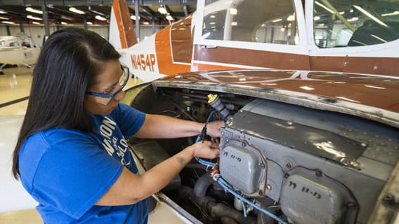 a person working on an airplane engine