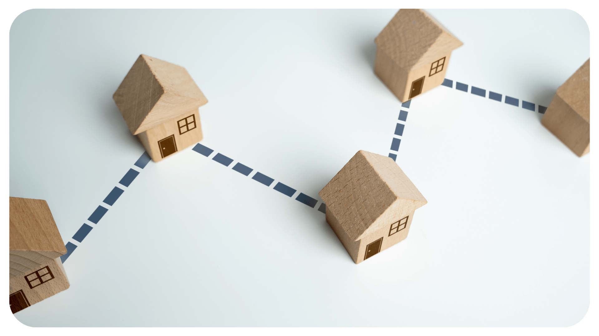 There are five small wooden houses connected together by a dotted line.