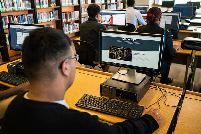 Someone working on their computer in a computer lab.