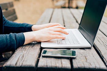 hands of woman on laptop