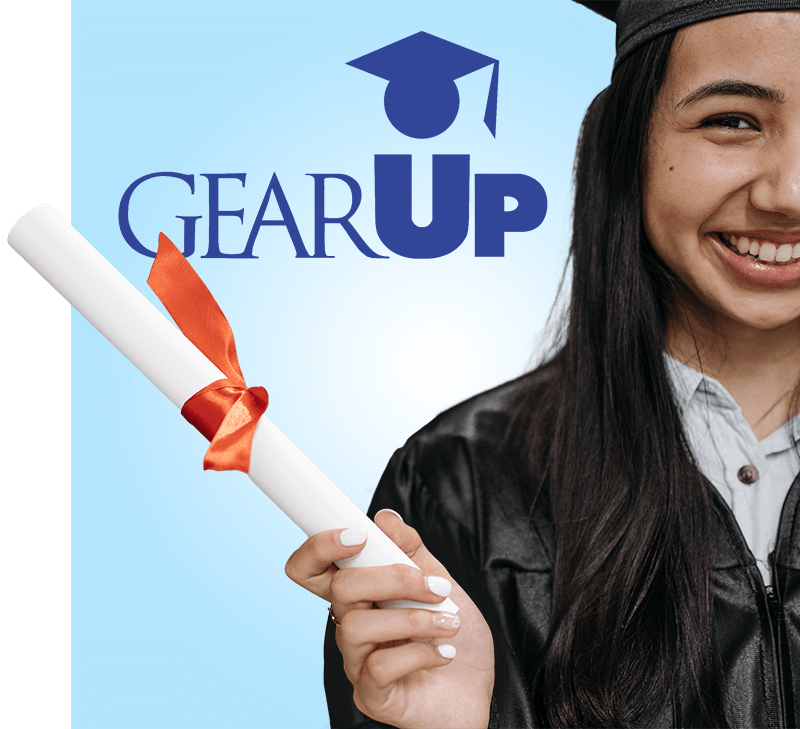 GEAR UP: High school student in graduation cap and gown smiling while posing with a diploma.