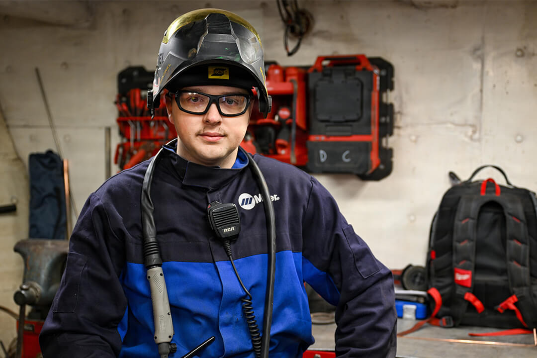 U.S. Coast Guard Petty Officer 2nd Class Alexander Van Horn, a damage controlman aboard Coast Guard Cutter Bristol Bay, stands in an engineering workspace equipped for welding and shipboard repairs.
