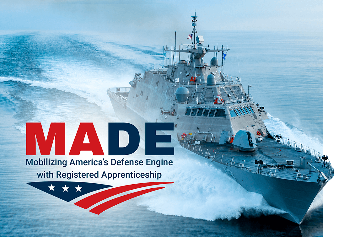 U.S. Navy littoral combat ship USS Wichita speeds across Lake Michigan, creating a large wake on calm blue water. Overlaid text reads “MADE — Mobilizing America’s Defense Engine with Registered Apprenticeship” with a patriotic red, white, and blue graphic.