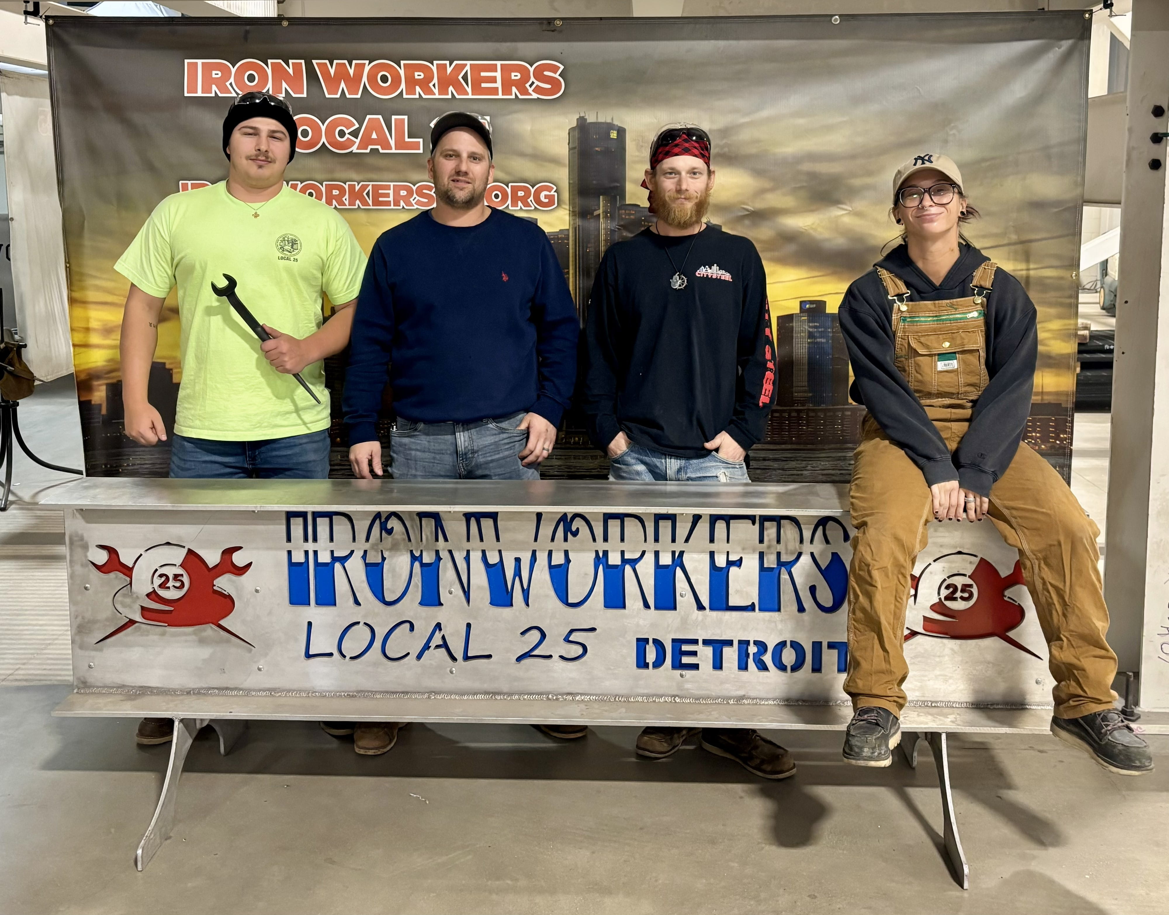 Anthony, Logan, Matt and Kellen standing in front of an Ironworkers Local 25 sign