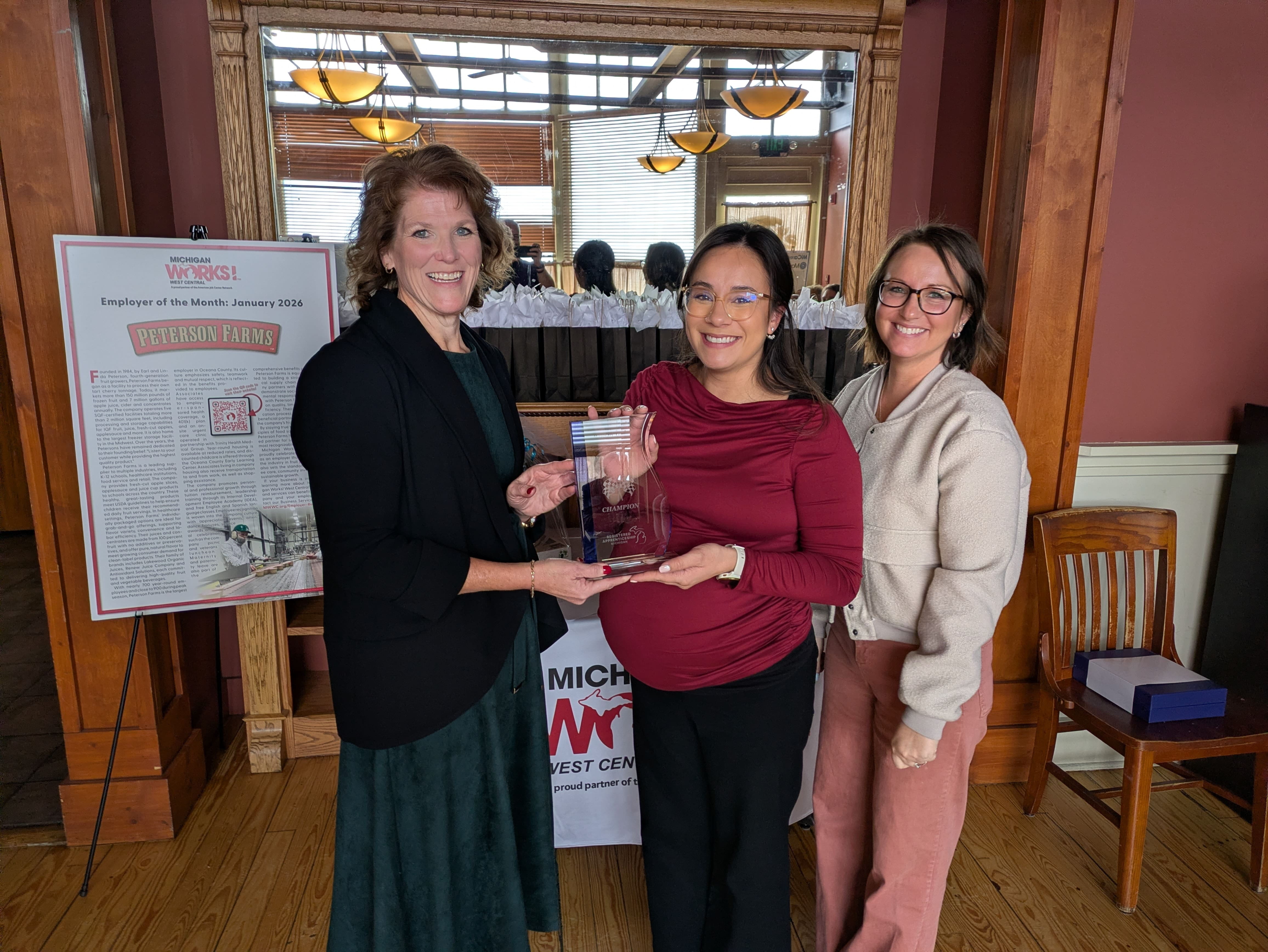 Shelly Keene handing an award to representatives from Corewell Health.