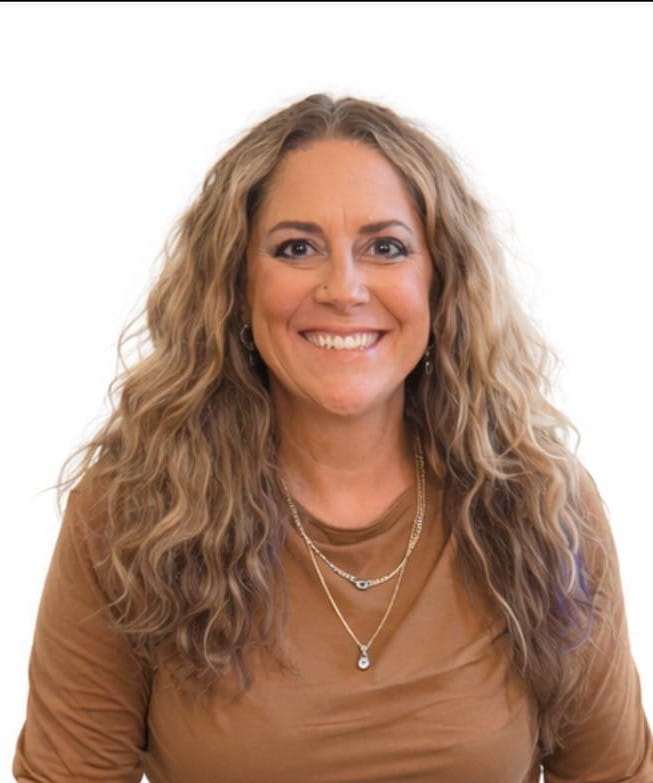 Candace, a white woman with wavy blonde hair wearing a brown shirt.