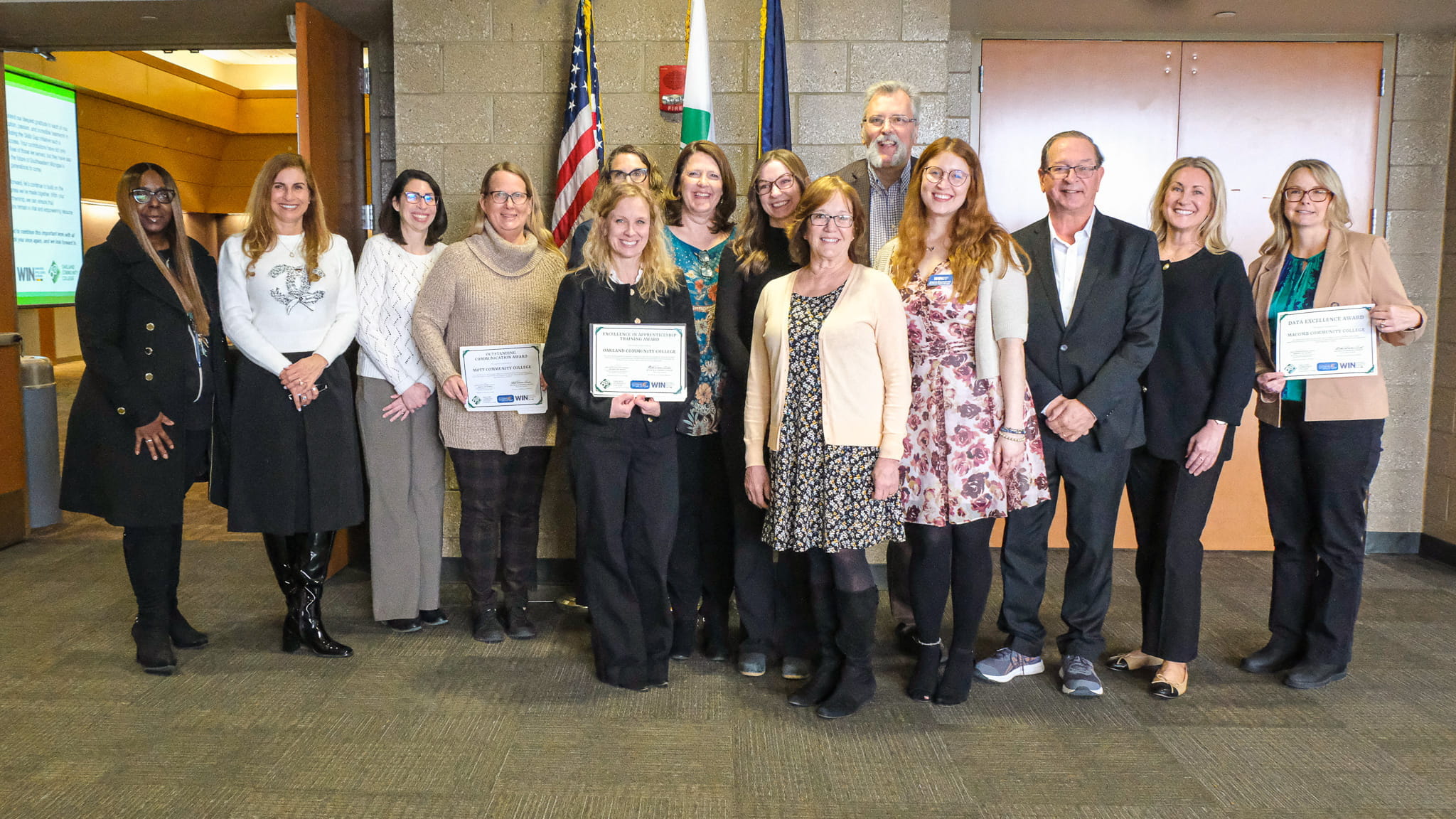 Group of WIN partners with several holding up certificates.