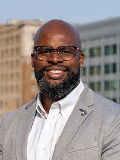 Randall Harrison outside with office buildings in background