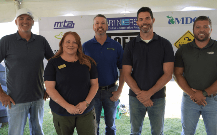 MIOSHA and Toebe Construction representatives standing together at an alliance renewal event.