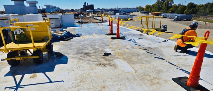 Roofing crew members from Schena Roofing & Sheet Metal Co. work safely using fall protection equipment purchased through MIOSHA’s MIWISH Grant Program.