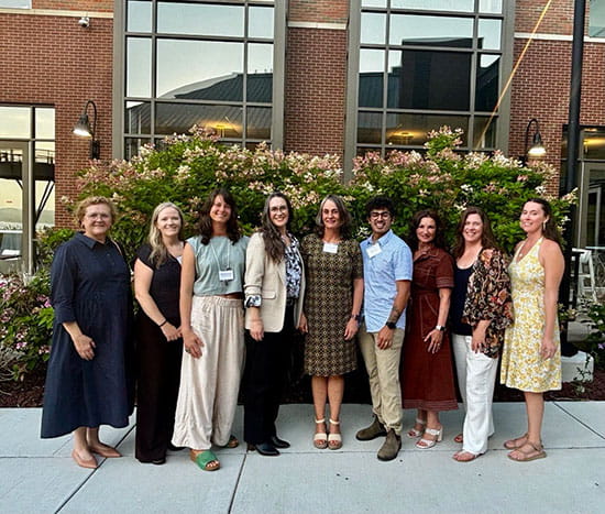 Menopause event panel standing outside smiling for group photo