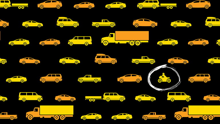 Cars, trucks and a motorcycle icon on a roadway
