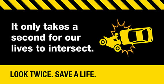 A motorcycle-vehicle crash with the caption, "It only takes a second for our lives to intersect. Look twice. Save a life." 
