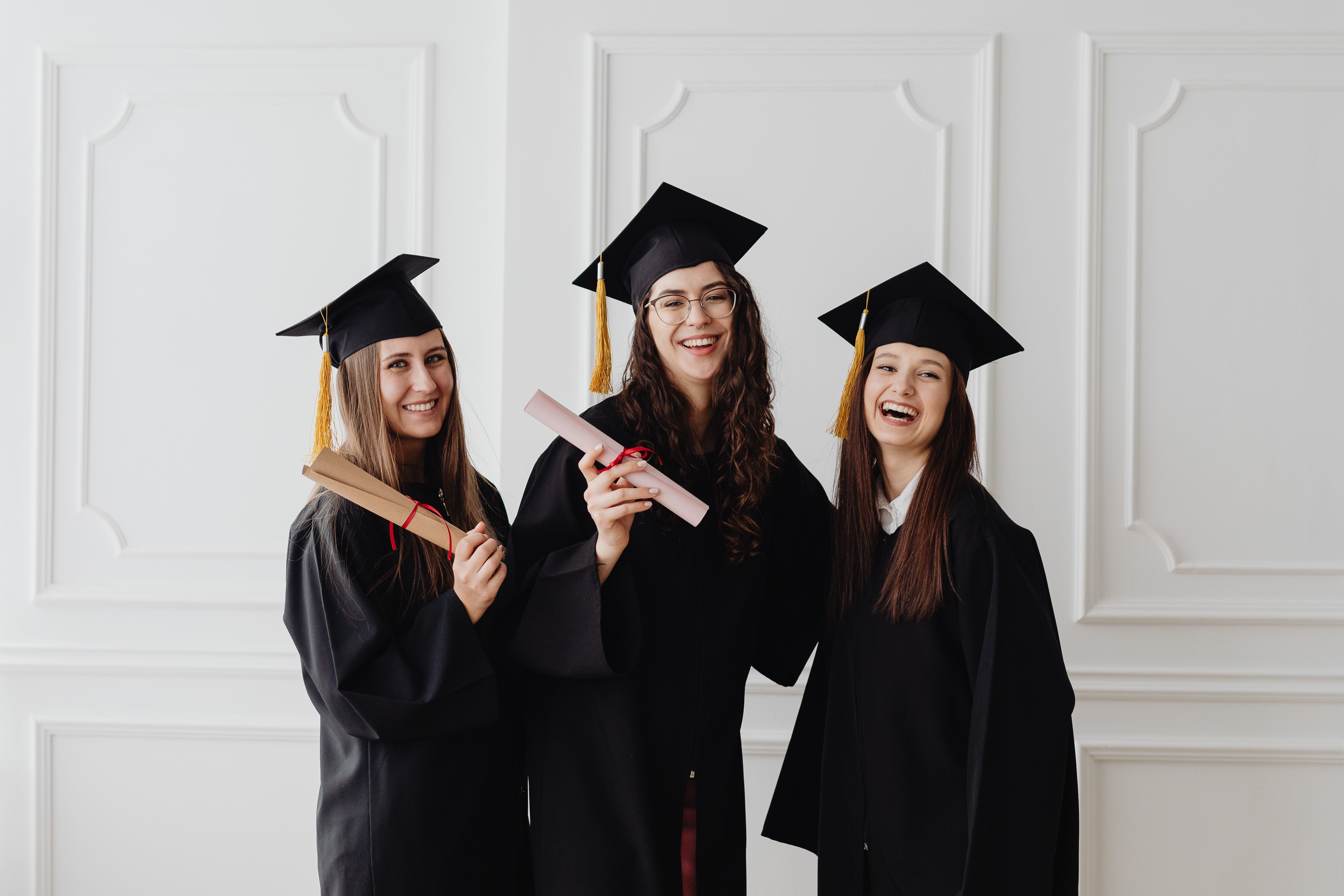 Three women celebrating graduation.