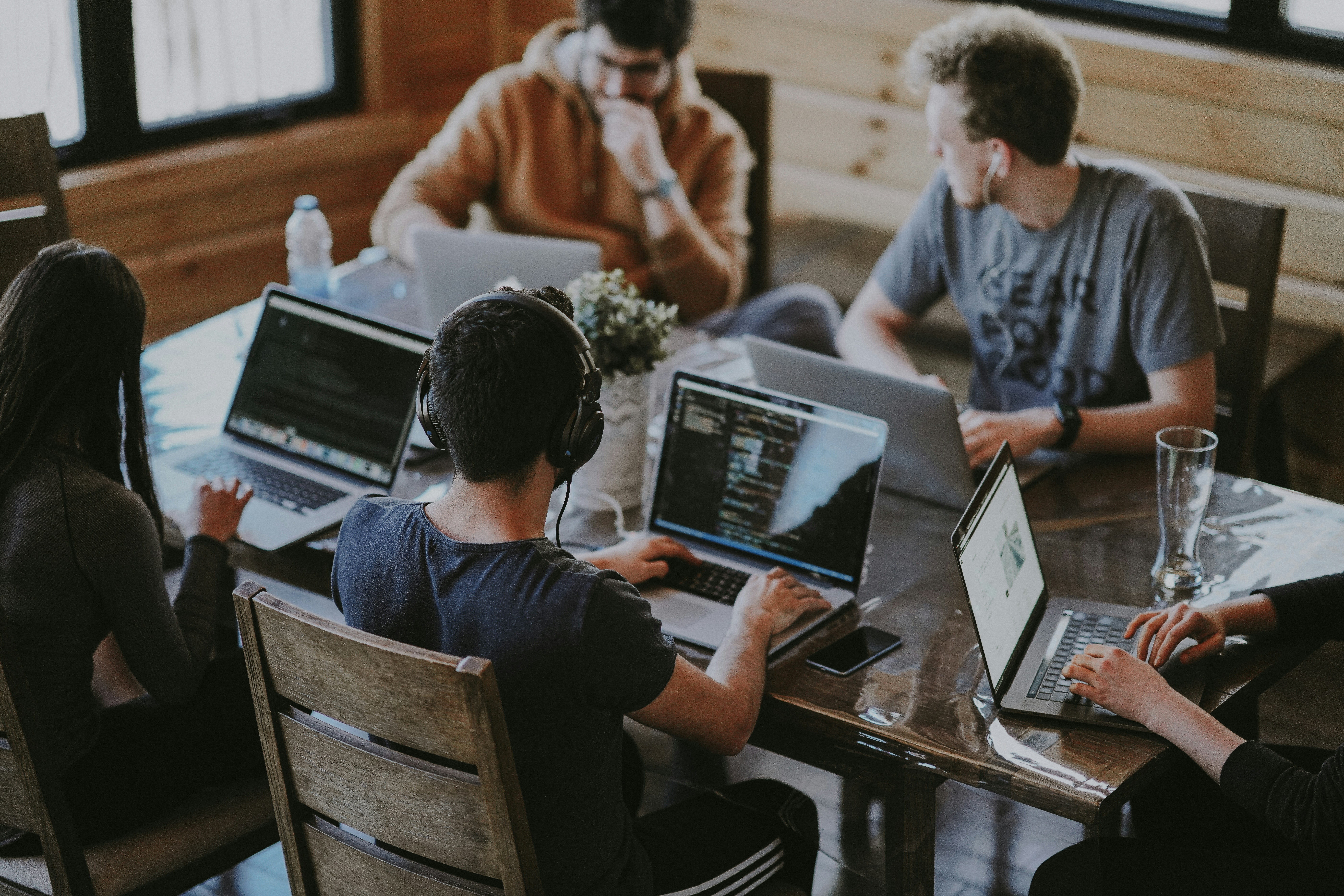 people sitting around a desk in an office