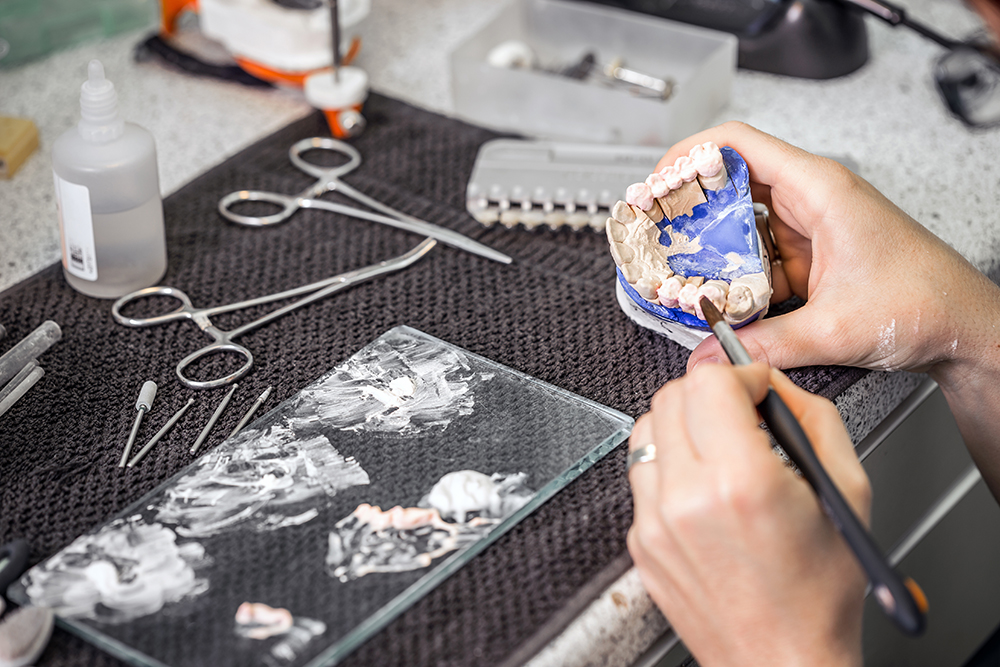 hands working on creating dentures